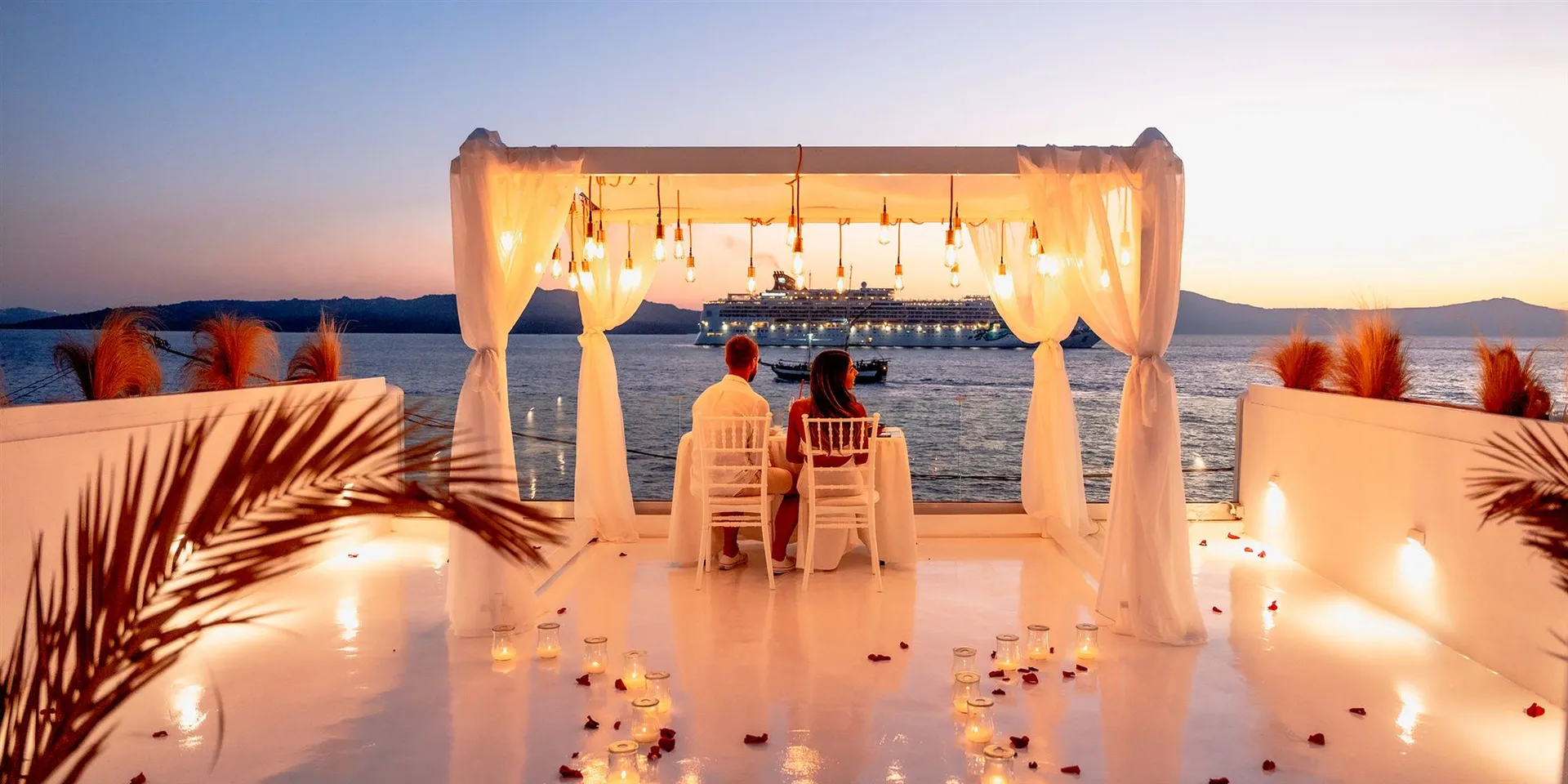 Marriage proposal on a Santorini caldera terrace at sunset