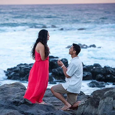 Beach proposal on the black sand of Santorini